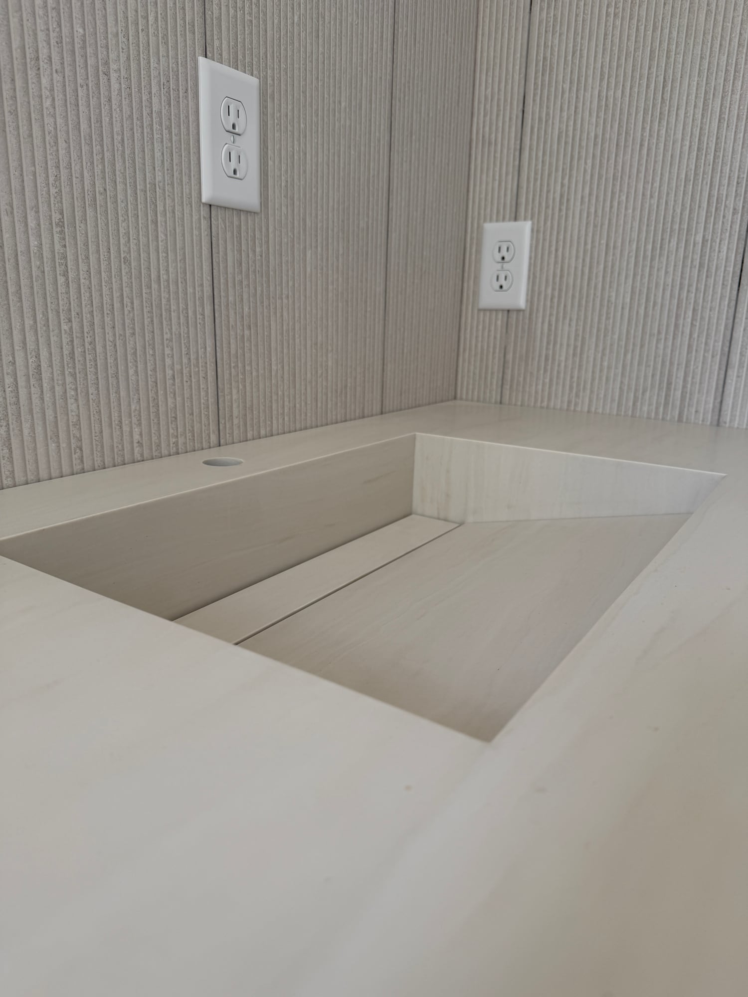 Close view of a pale integrated sink before faucet installation